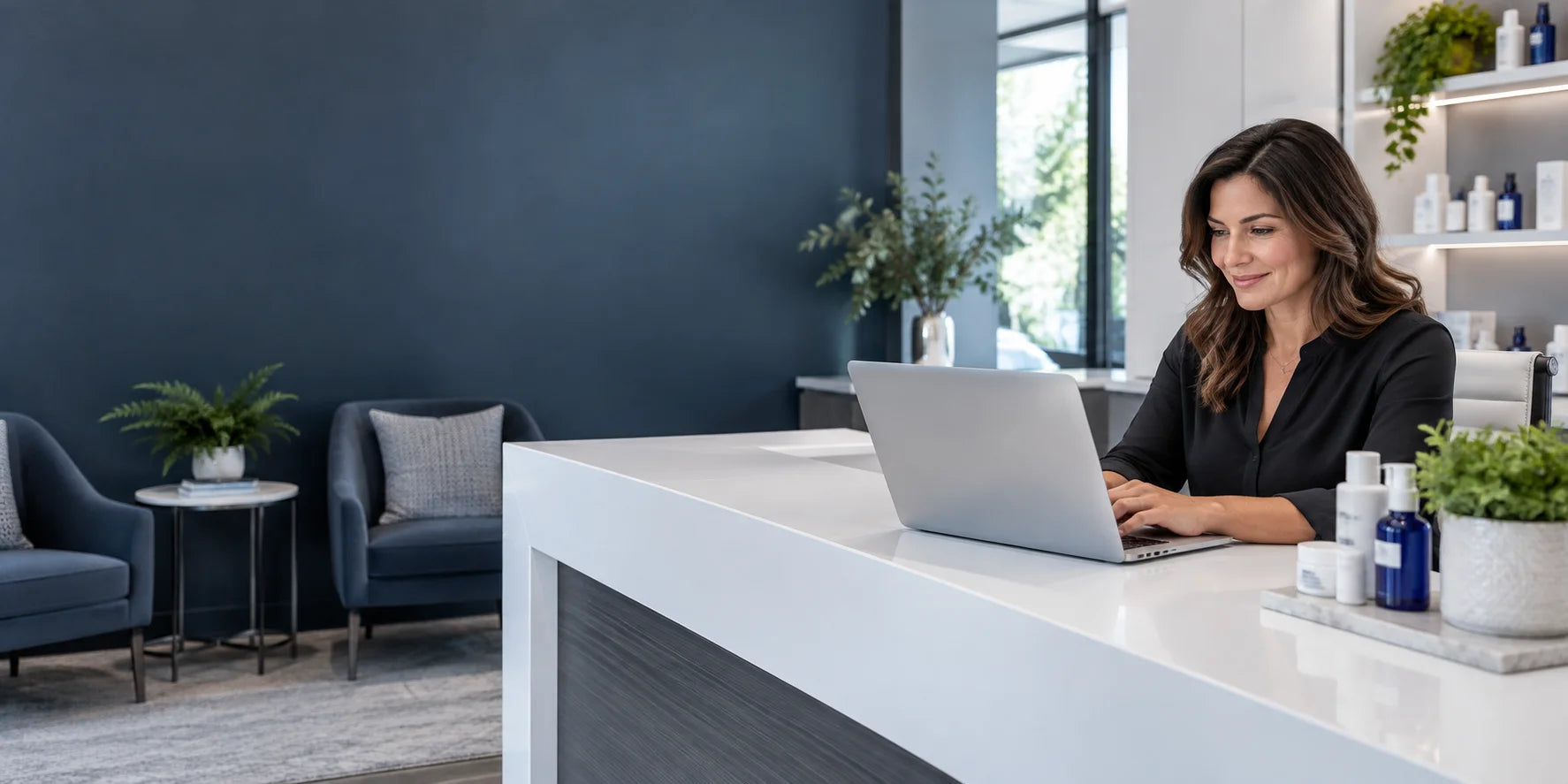 Illustrative wellness practice workspace with a manager using a laptop
